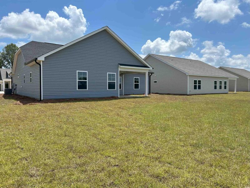 Rear view of house with a yard