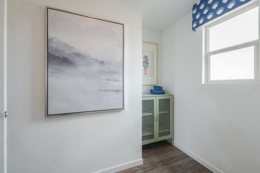 A room with a picture on the wall.