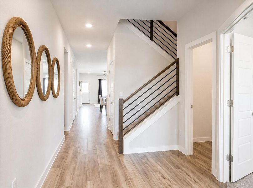 Crisp white walls and clean-lined stairs accent the wood-look flooring in this welcoming entry hall. Crisp white walls and clean-lined stairs accent the wood-look flooring in this welcoming entry hall.