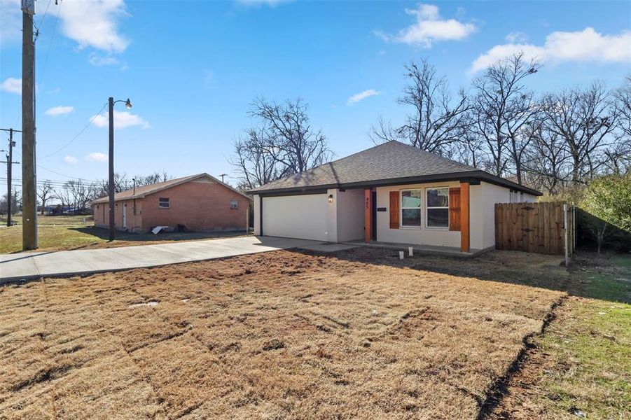 Ranch-style house with a front yard and a garage