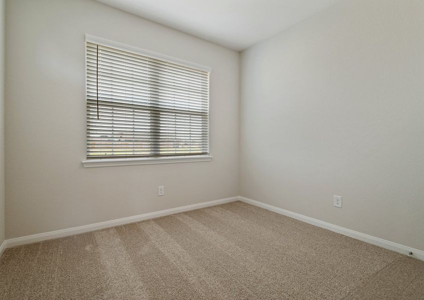 Secondary bedroom with lush carpet