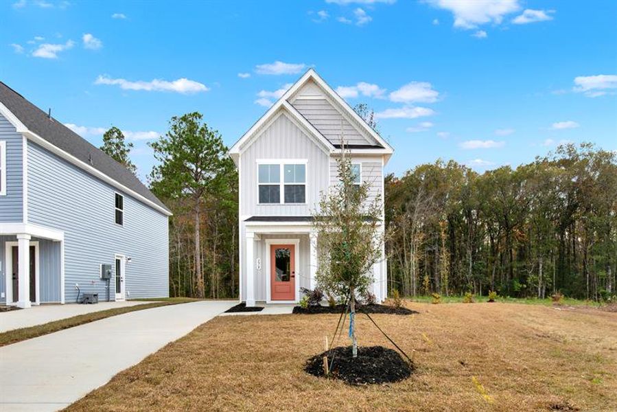 Front exterior of a new home in Royal Oaks Cottages, Hardeeville, SC, highlighting curb appeal (Image 1). Front exterior of a new home in Royal Oaks Cottages, Hardeeville, SC, highlighting curb appeal (Image 1).