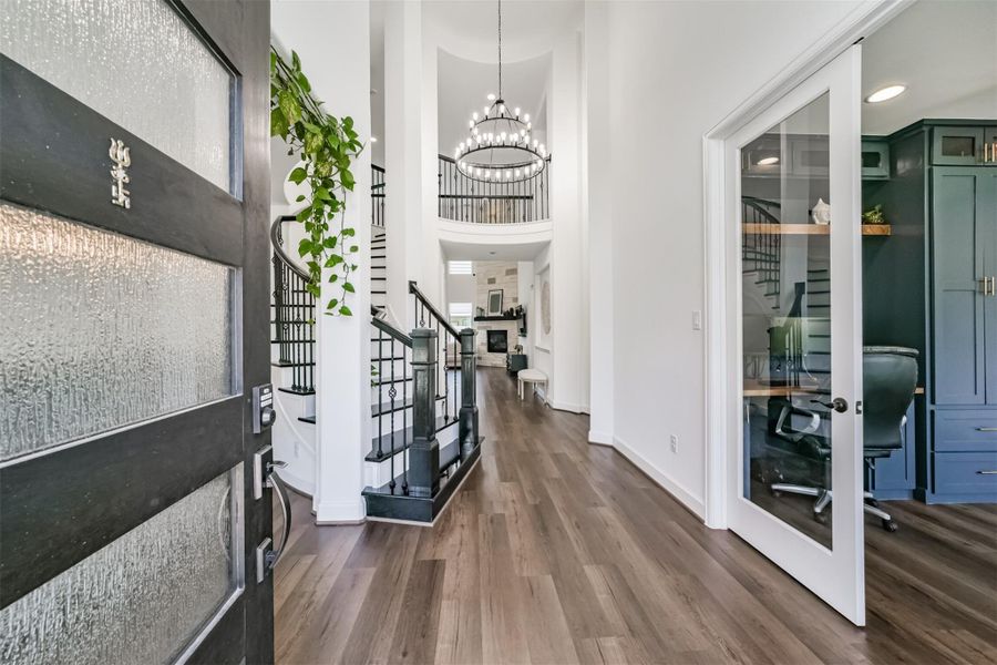 A nine-foot door featuring frosted glass adds a touch of elegance, while French doors with glass panels create a seamless transition into the study or home office. A winding staircase ascends gracefully to the rotunda ceiling. A nine-foot door featuring frosted glass adds a touch of elegance, while French doors with glass panels create a seamless transition into the study or home office. A winding staircase ascends gracefully to the rotunda ceiling.