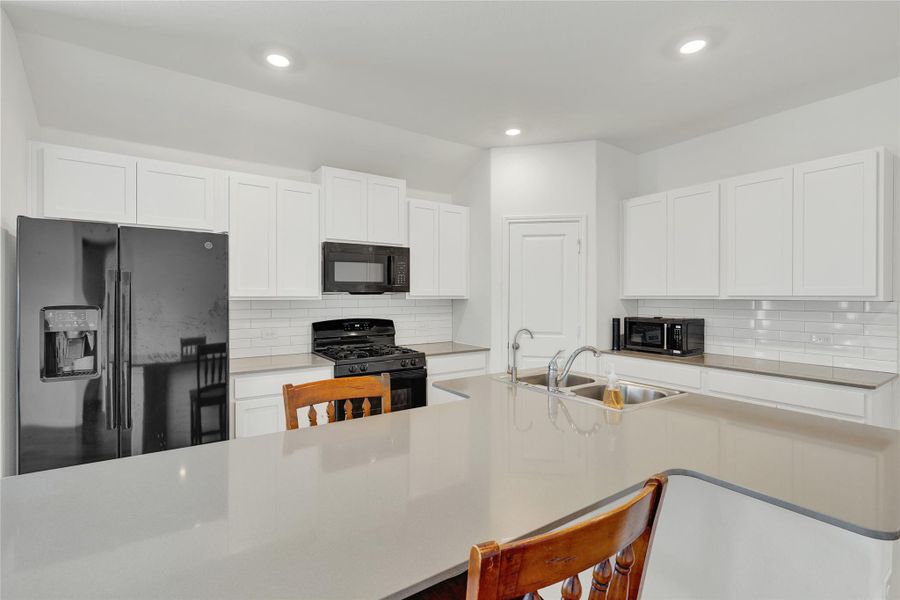 A contemporary kitchen showcasing ample countertop space and essential culinary appliances.