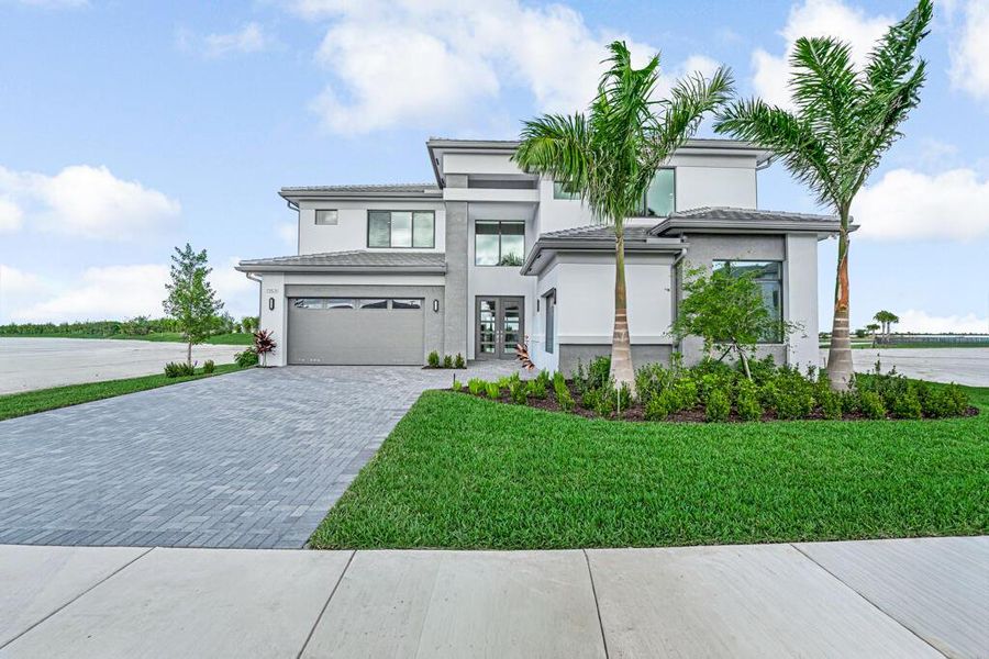 Front exterior of a new home in Apex at Avenir, Palm Beach Gardens, FL, highlighting curb appeal (Image 21). Front exterior of a new home in Apex at Avenir, Palm Beach Gardens, FL, highlighting curb appeal (Image 21).
