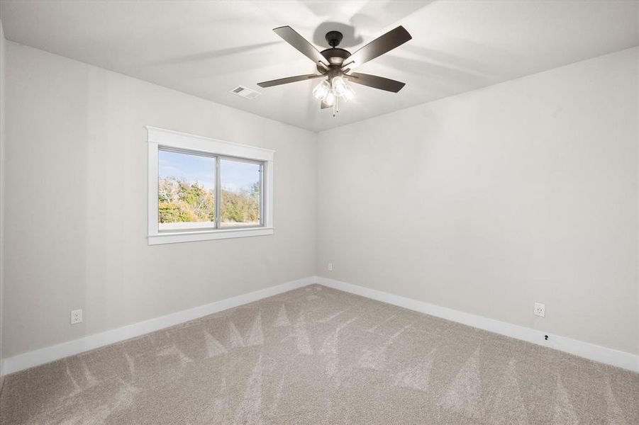 Empty room with carpet and ceiling fan