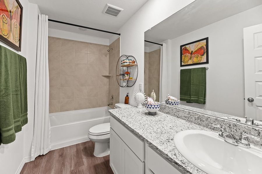 A bathroom with a marble countertop.