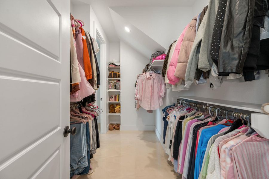 Ample storage solutions are cleverly integrated into this bright, well-organized walk-in closet. Ample storage solutions are cleverly integrated into this bright, well-organized walk-in closet.