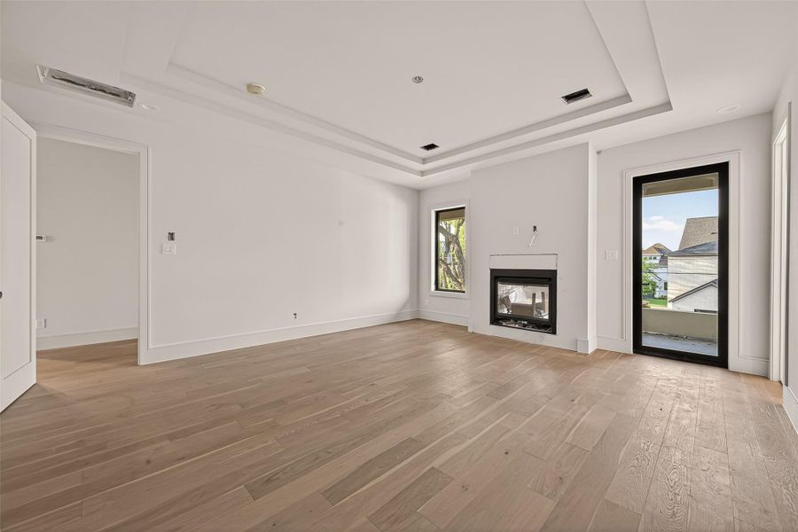 Large primary bedroom with double sided fire place