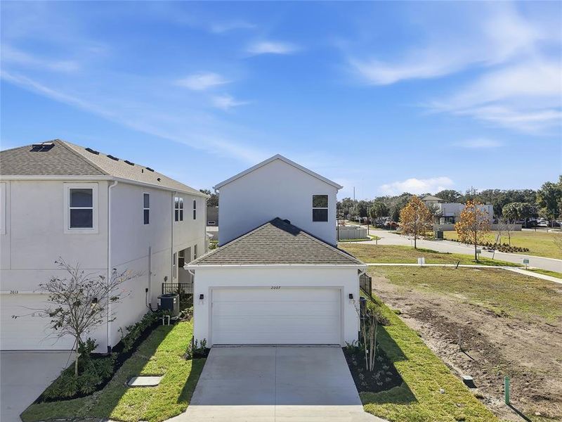 Front exterior of a new home in Vivir, Valrico, FL, highlighting curb appeal (Image 25).