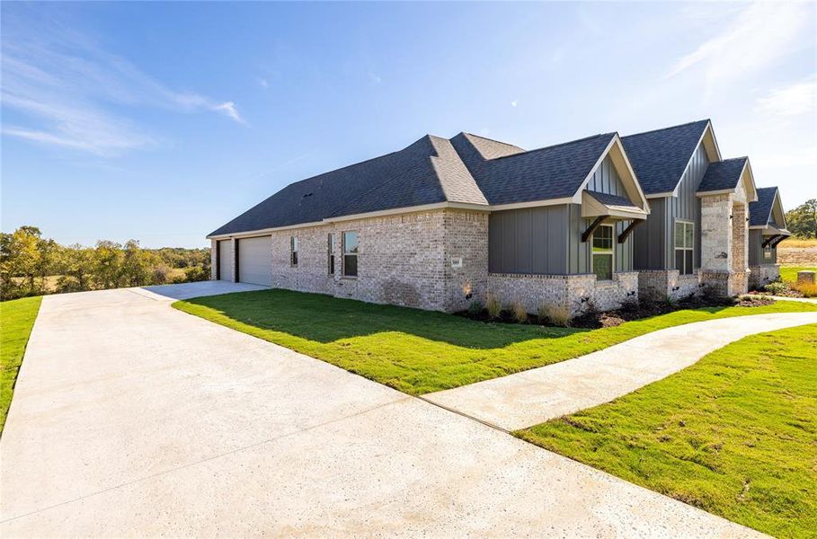 View of property exterior with a lawn and a garage