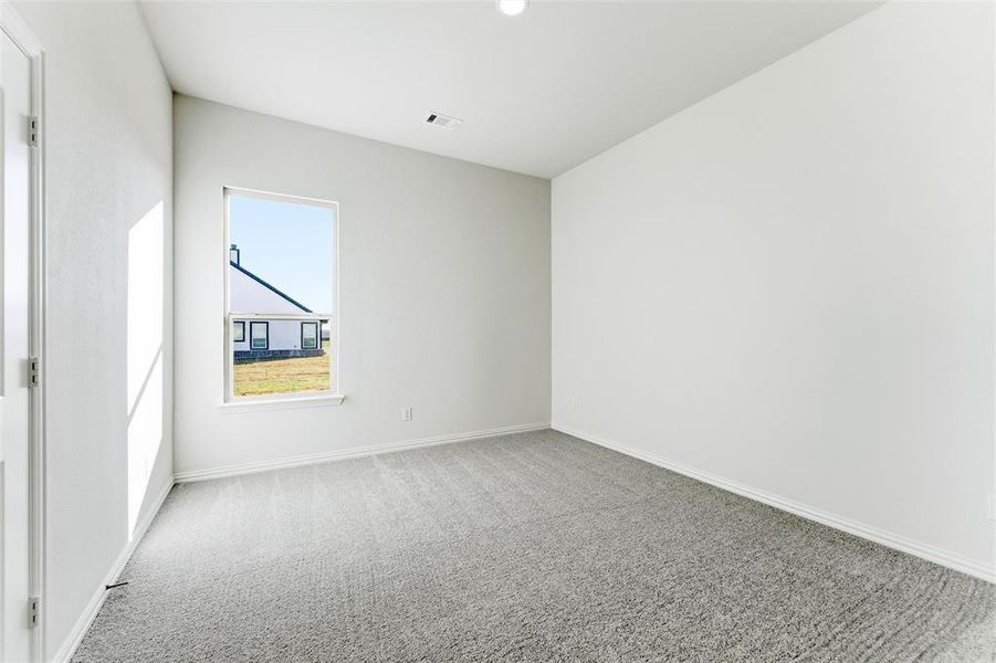 Unfurnished room with light colored carpet and baseboards