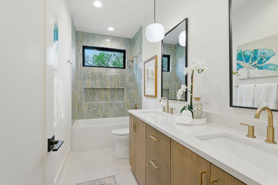 Full bathroom featuring double vanity, bathing tub / shower combination, tile patterned floors, and recessed lighting