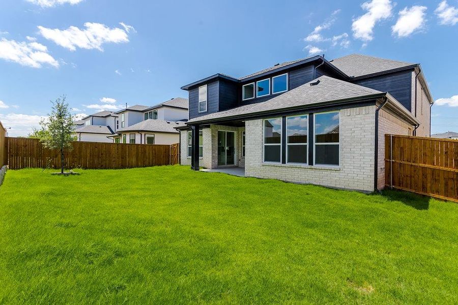 Rear view of house featuring a yard