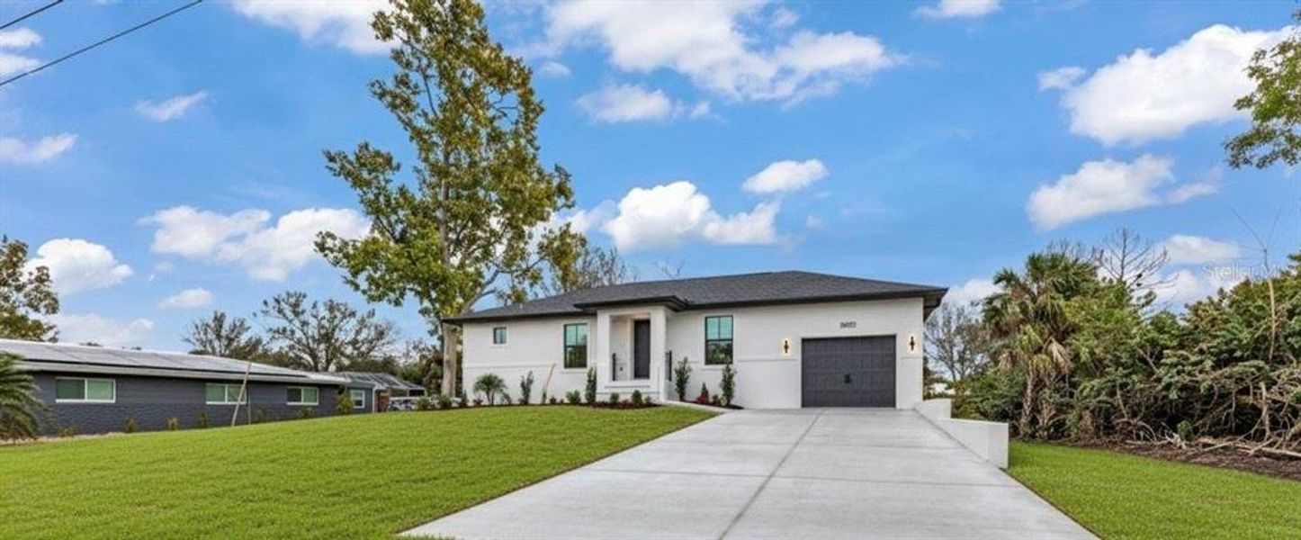 Front exterior of a new home in , Punta Gorda, FL, highlighting curb appeal (Image 21).