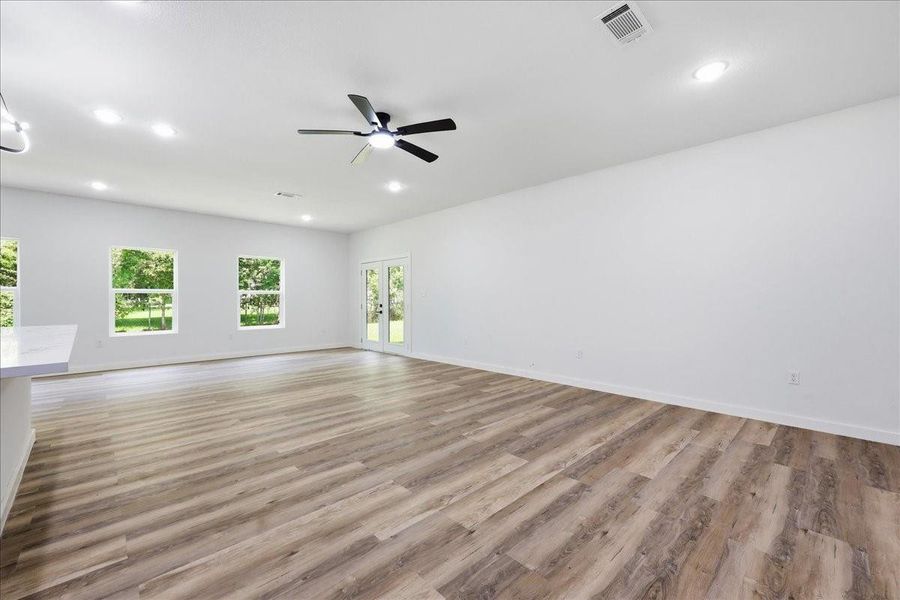 The sprawling family room provides endless layout options for furniture and entertainment setups. The sprawling family room provides endless layout options for furniture and entertainment setups.