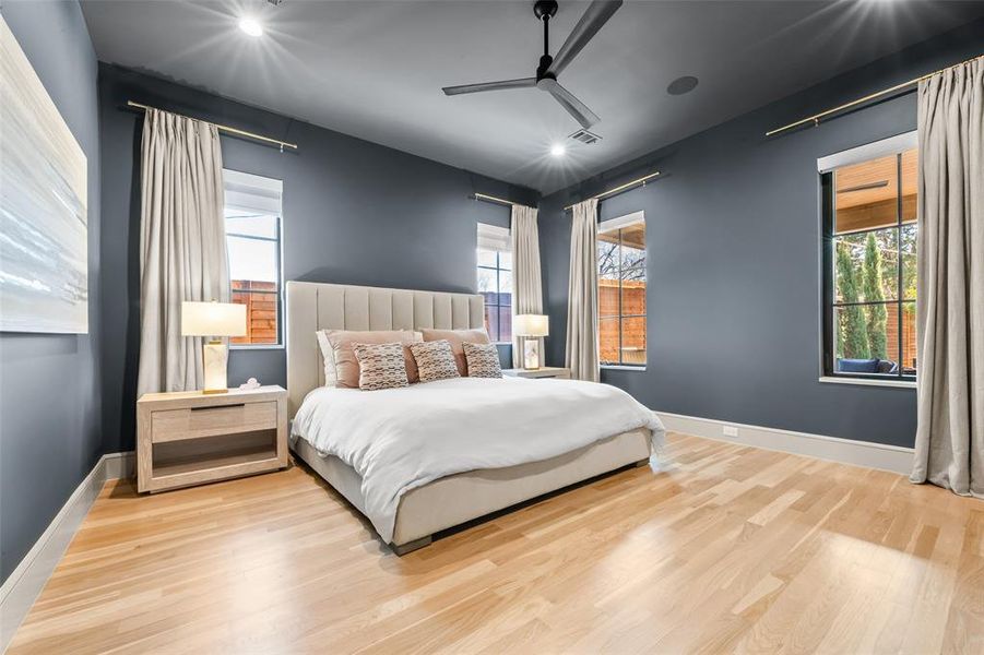Primary bedroom featuring wood finished floors and ceiling fan