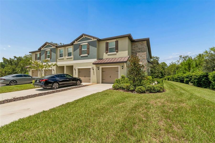 Front exterior of a new home in , Land O' Lakes, FL, highlighting curb appeal (Image 27).