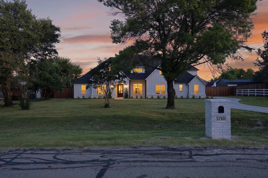 Contemporary residence featuring a light-colored exterior with dark trim and a prominent black front door Contemporary residence featuring a light-colored exterior with dark trim and a prominent black front door