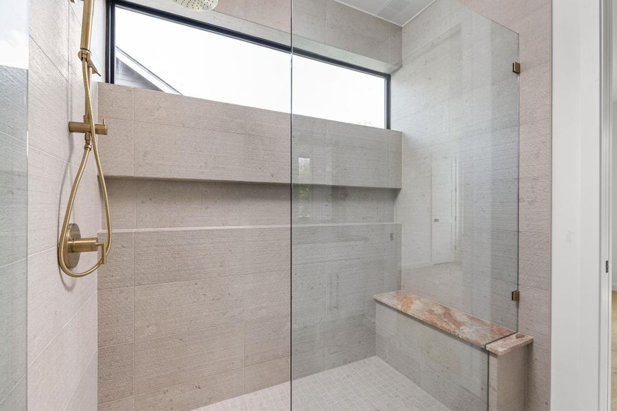 Full bath featuring tiled shower