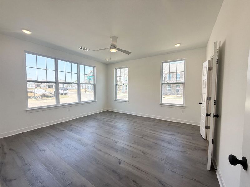 Spare room with a ceiling fan, dark wood finished floors, and recessed lighting