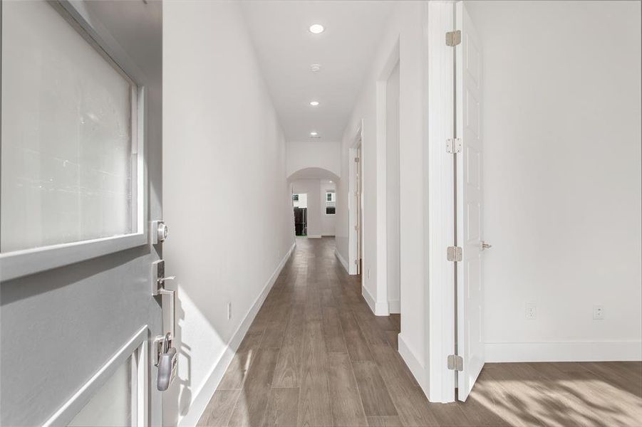 Hall with light hardwood / wood-style flooring