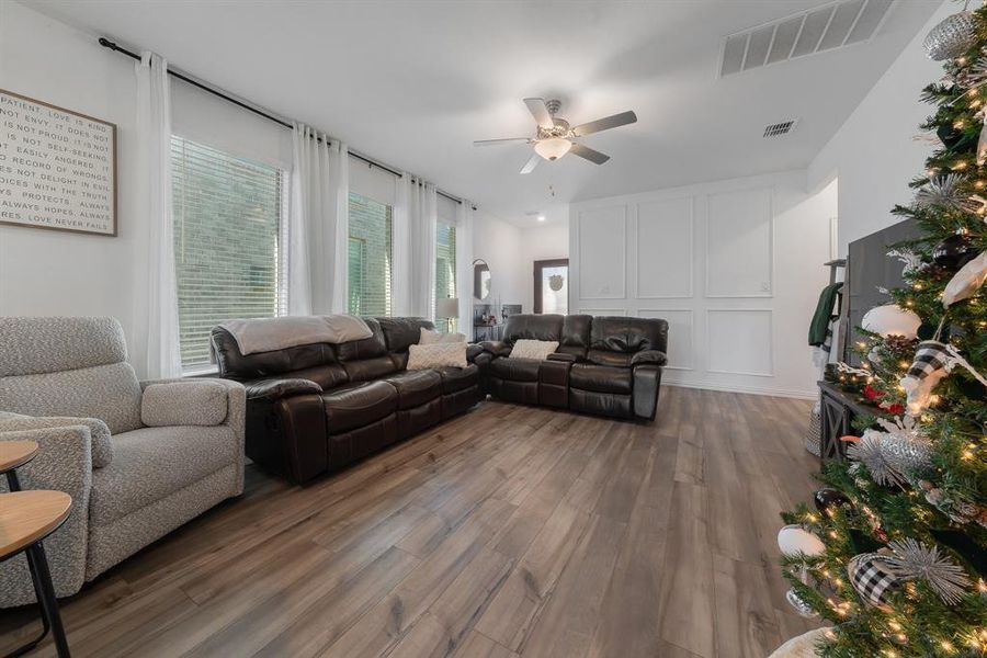 Living room featuring ceiling fan and dark hardwood / wood-style floors