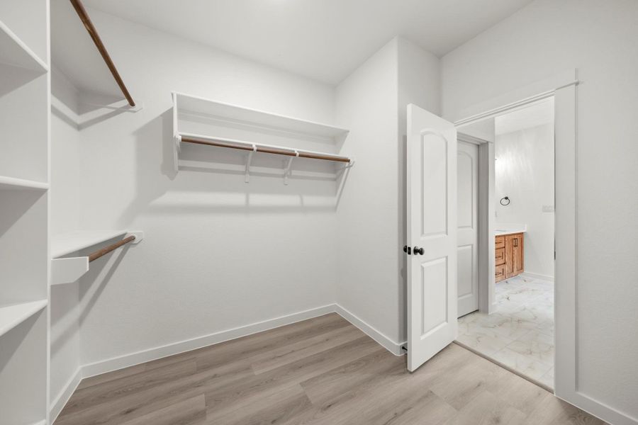Functional and generous, this walk-in closet offers ample storage and direct access to a well-appointed bathroom. Functional and generous, this walk-in closet offers ample storage and direct access to a well-appointed bathroom.