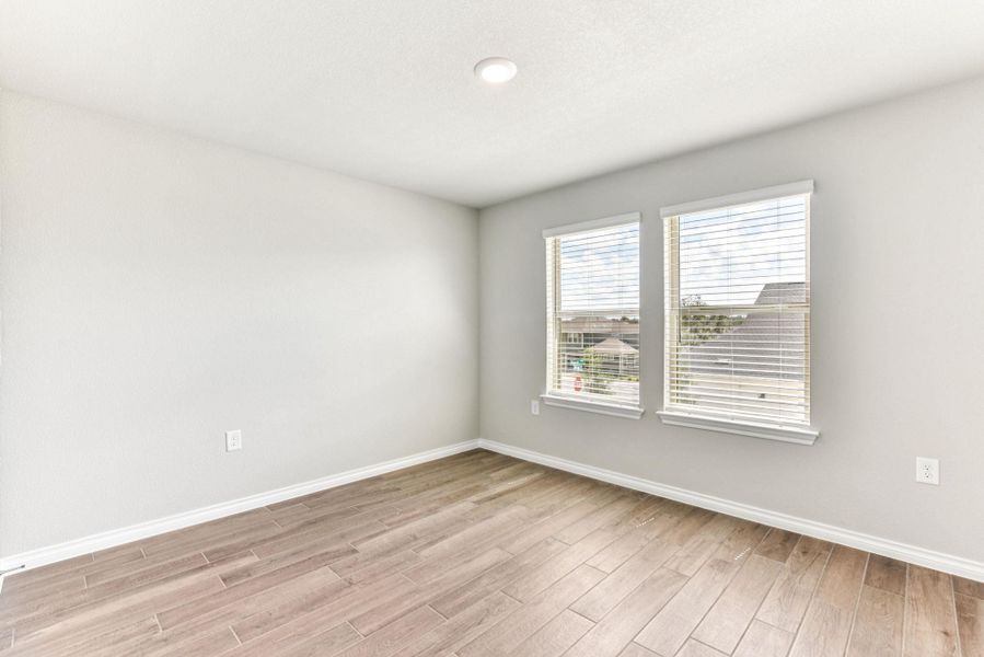 Spare room with baseboards and light wood finished floors Spare room with baseboards and light wood finished floors