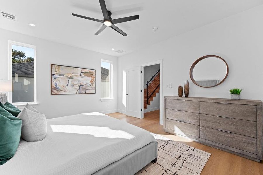 Bedroom with light hardwood / wood-style flooring and ceiling fan