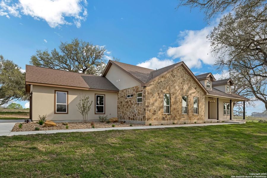 Front exterior of a new home in , Floresville, TX, highlighting curb appeal (Image 22). Front exterior of a new home in , Floresville, TX, highlighting curb appeal (Image 22).