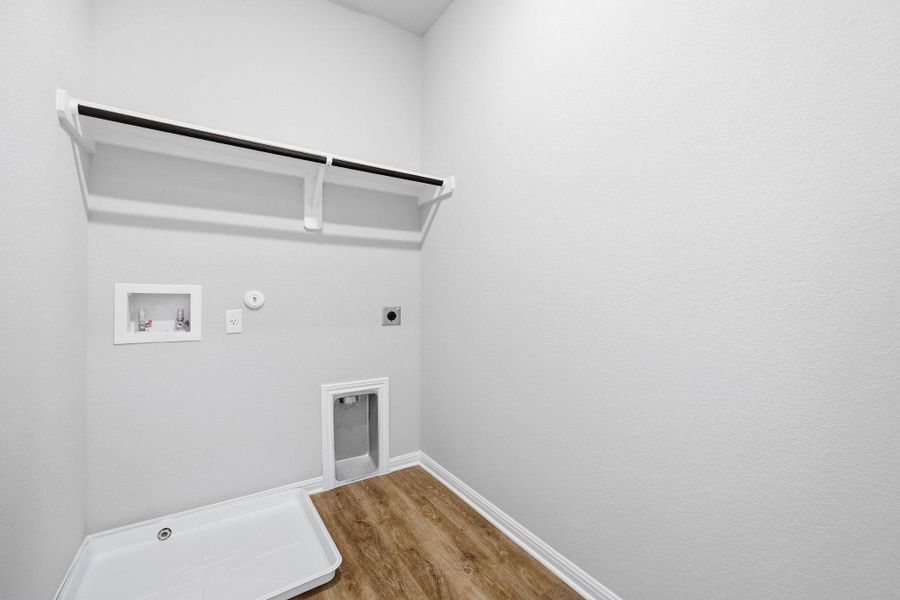 Laundry room featuring gas dryer hookup, wood finished floors, washer hookup, and hookup for an electric dryer