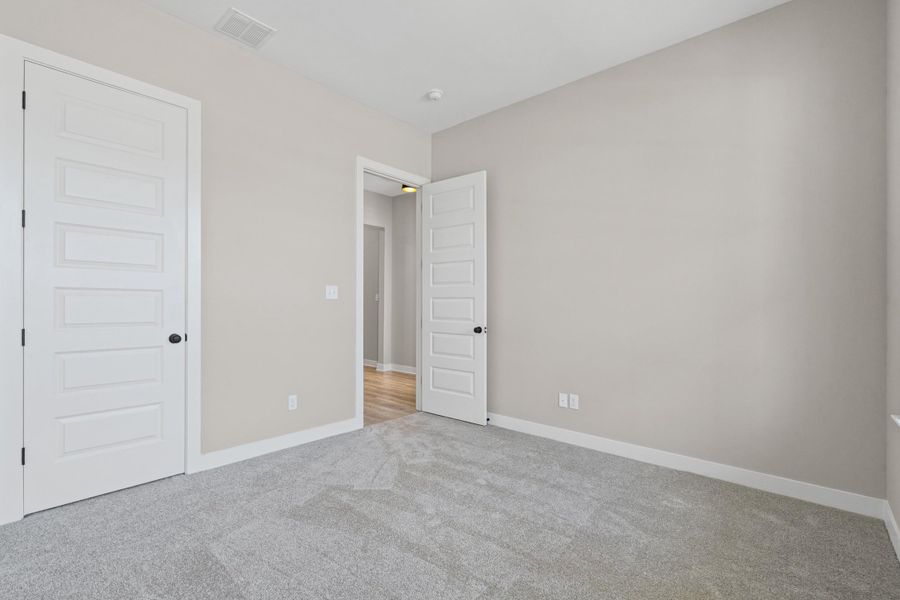 Carpeted room with light neutral wall paint Carpeted room with light neutral wall paint