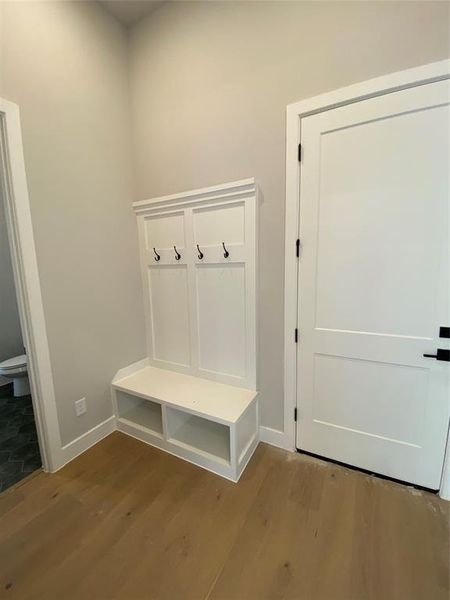 Mudroom featuring baseboards and dark wood-style flooring