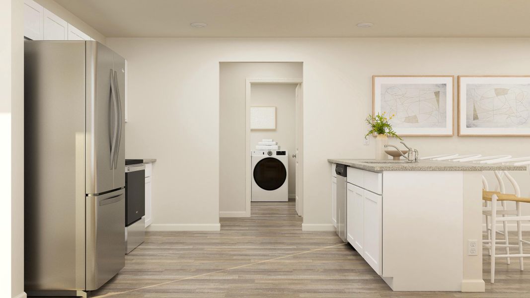 A kitchen with white cabinets.