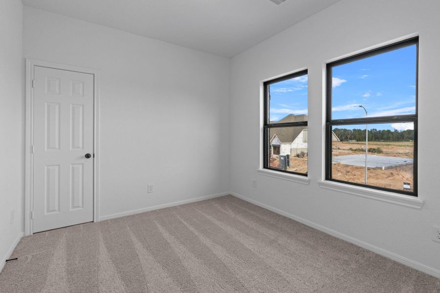 Your secondary bedroom features plush carpet, fresh paint, closet, and a large window that lets in plenty of natural lighting.
