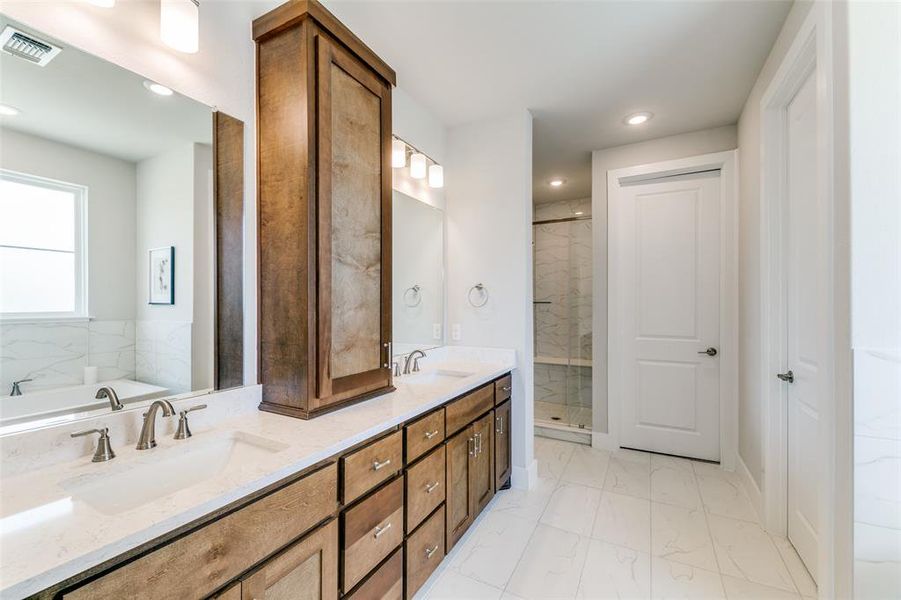 Bathroom with vanity and separate shower and tub