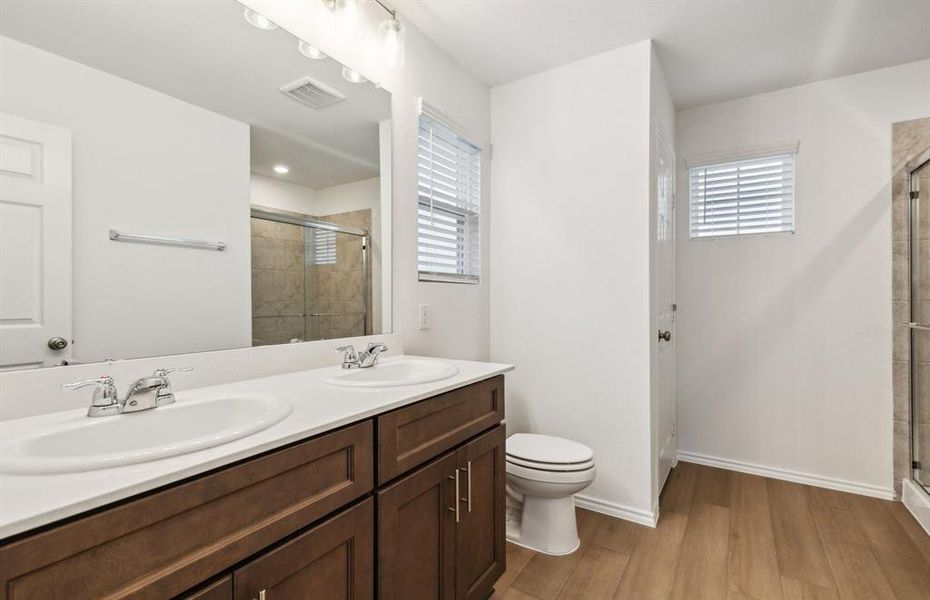 Spacious owner's suite with dual vanity *real home pictured