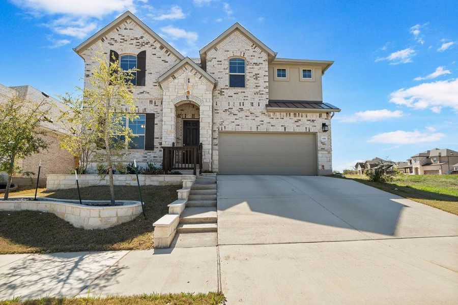 French provincial home with driveway, an attached garage, brick siding, and a standing seam roof French provincial home with driveway, an attached garage, brick siding, and a standing seam roof
