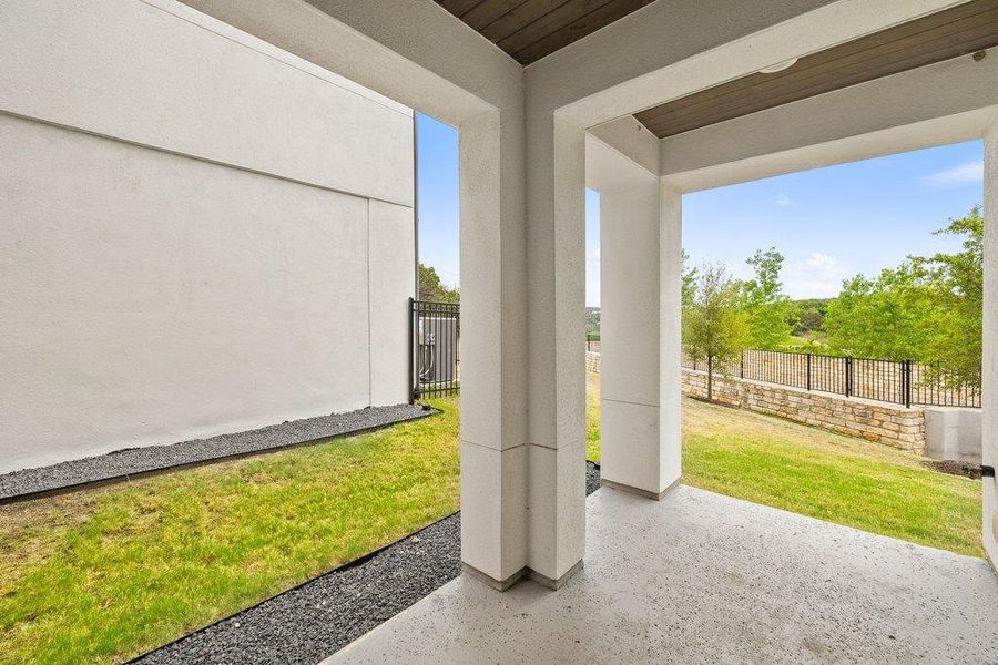 Covered patio featuring a wood-finish ceiling and concrete flooring
