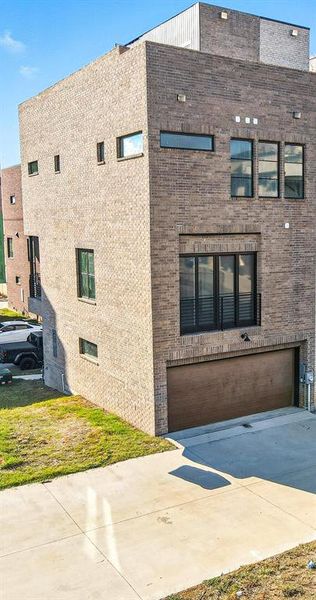 View of side of property with brick siding and a yard View of side of property with brick siding and a yard