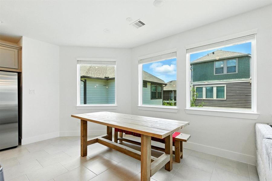 This dining room is bathed in naturallight streaming through expansivewindows. This dining room is bathed in naturallight streaming through expansivewindows.