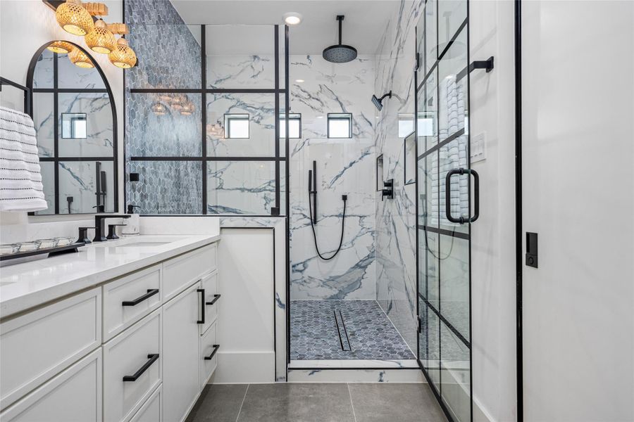 Relax freely in the freestanding tub enclosed within the glass shower—no water splashing, just indulgent calm.