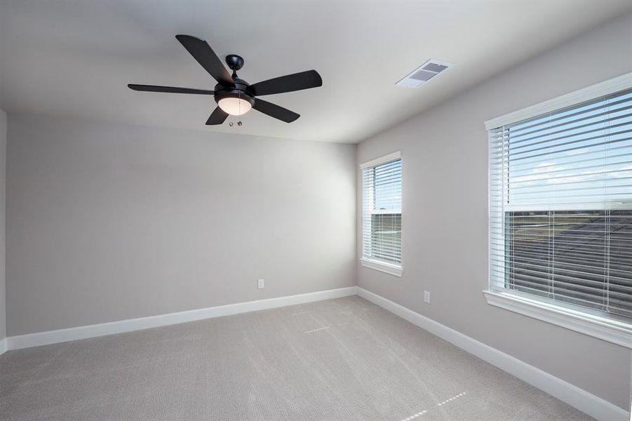 The secondary bedrooms are spacious and feature large picturesque windows.