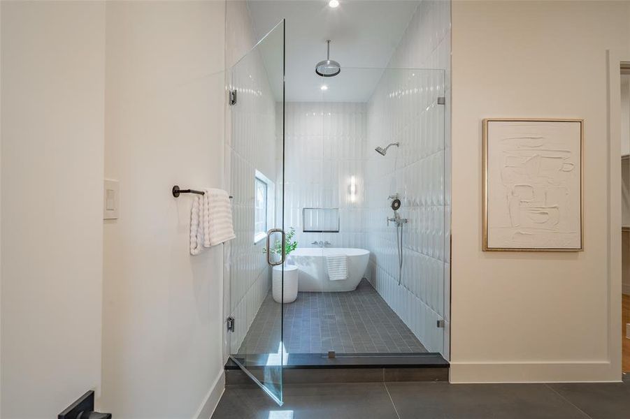 Bathroom featuring tile patterned flooring and independent shower and bath