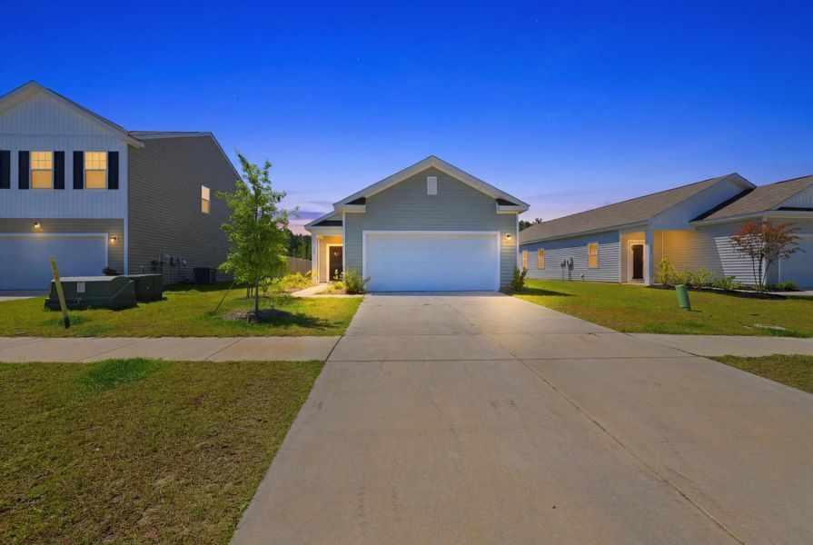 Front exterior of a new home in Pender Woods at Cane Bay, Summerville, SC, highlighting curb appeal (Image 15). Front exterior of a new home in Pender Woods at Cane Bay, Summerville, SC, highlighting curb appeal (Image 15).
