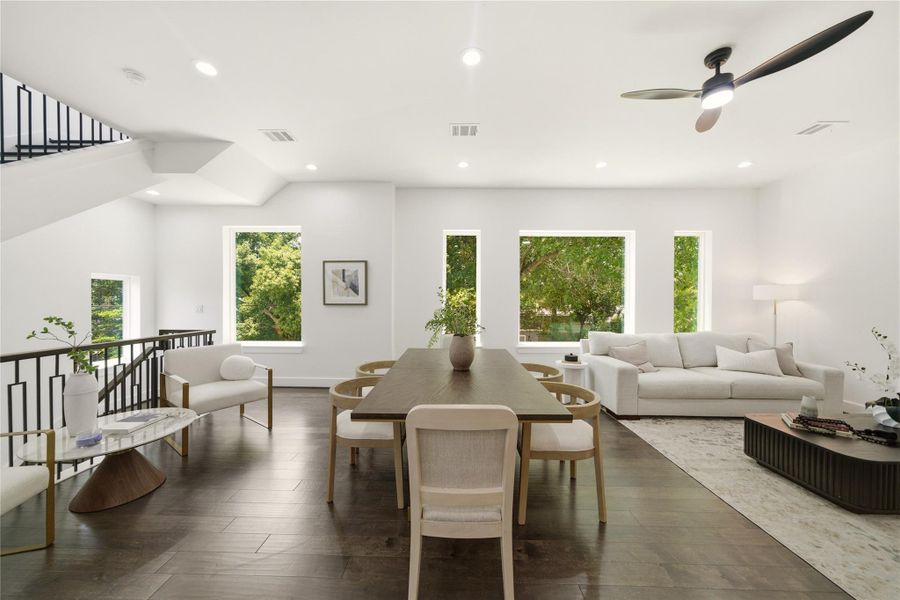 Large windows that allow plenty of natural light and frame the beautiful trees that surround the property.