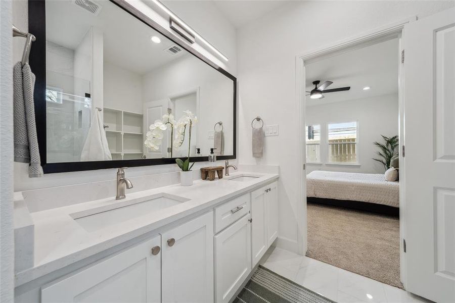 Bathroom featuring dounble vanity, tile patterned flooring, and ceiling fan