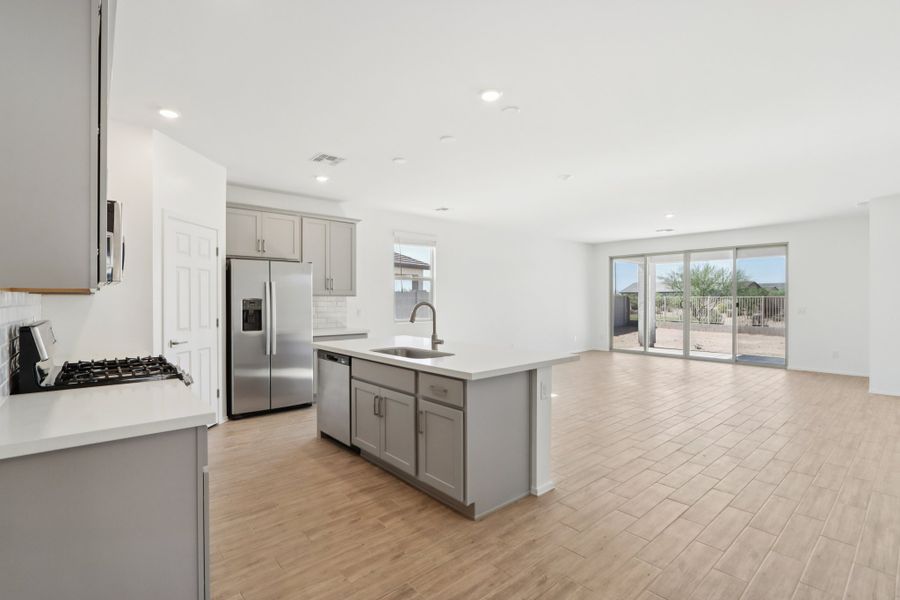Kitchen, dining and great room. Finishes and options may vary by community.