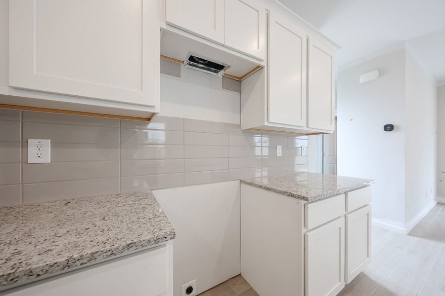 A kitchen with white cabinets. A kitchen with white cabinets.